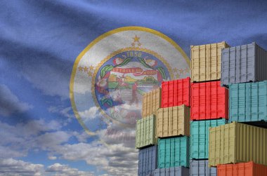 Minnesota US state flag and big stack of shipping cargo containers in docks with sky background close up clipart