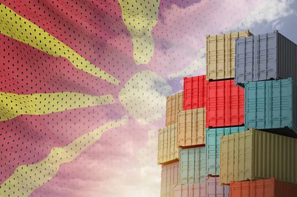 Stock image Macedonia flag and big stack of shipping cargo containers in docks with sky background close up