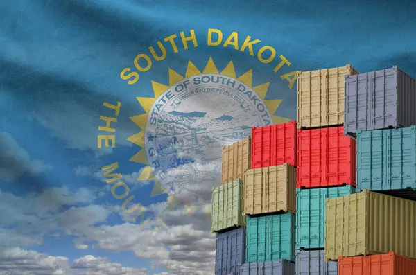 stock image South Dakota US state flag and big stack of shipping cargo containers in docks with sky background close up