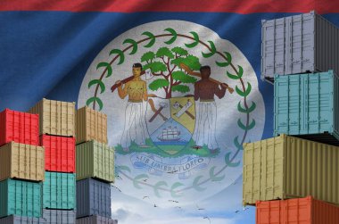 Belize flag and big stack of shipping cargo containers in docks with sky background close up clipart