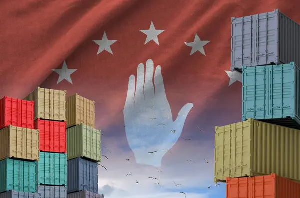 stock image Abkhazia flag and big stack of shipping cargo containers in docks with sky background close up