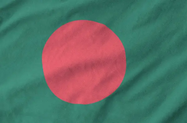 stock image Bangladesh flag depicted on folded wavy fabric of old cloth close up