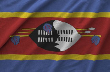 Swaziland flag depicted on folded wavy fabric of old cloth close up clipart