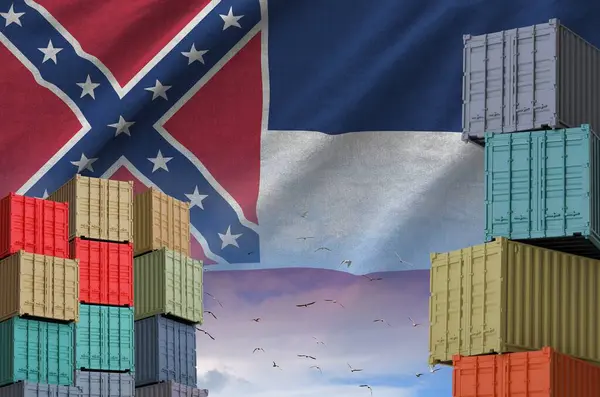 Stock image Mississippi new US state flag and big stack of shipping cargo containers in docks with sky background close up