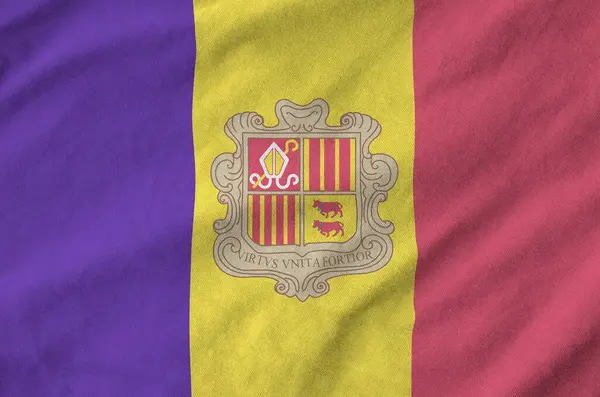 stock image Andorra flag depicted on folded wavy fabric of old cloth close up