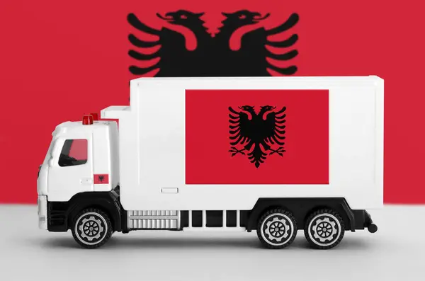 stock image Albania flag depicted on side wall of white delivery van close up. Shipping and local delivery concept