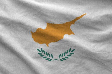 Cyprus flag depicted on folded wavy fabric of old cloth close up clipart