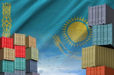 Kazakhstan flag and big stack of shipping cargo containers in docks with sky background close up clipart