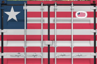 Liberia flag depicted on metal doors of shipping cargo container outdoors in docks area close up clipart