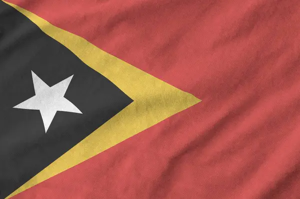 stock image Timor Leste flag depicted on folded wavy fabric of old cloth close up