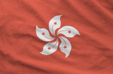 Hong kong flag depicted on folded wavy fabric of old cloth close up clipart