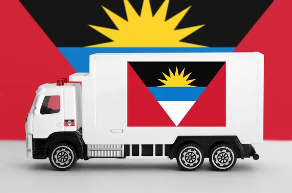 stock image Antigua and Barbuda flag depicted on side wall of white delivery van close up. Shipping and local delivery concept