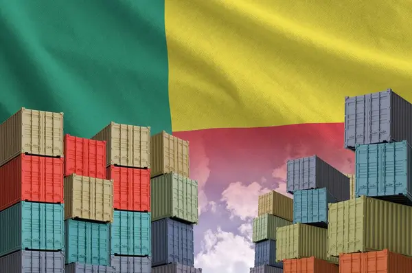 Stock image Benin flag and big stack of shipping cargo containers in docks with sky background close up