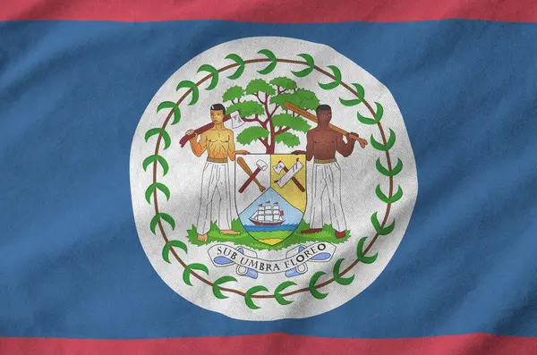 stock image Belize flag depicted on folded wavy fabric of old cloth close up