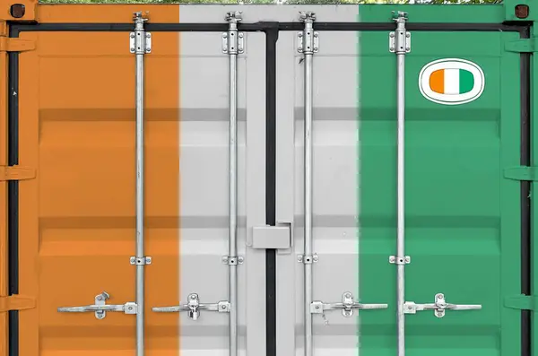 stock image Ivory Coast flag depicted on metal doors of shipping cargo container outdoors in docks area close up
