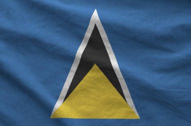 Saint Lucia flag depicted on folded wavy fabric of old cloth close up clipart