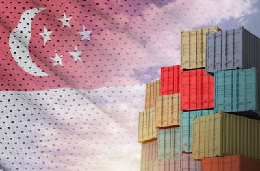 Singapore flag and big stack of shipping cargo containers in docks with sky background close up clipart