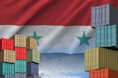 Syria flag and big stack of shipping cargo containers in docks with sky background close up clipart