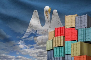 Louisiana US state flag and big stack of shipping cargo containers in docks with sky background close up clipart