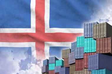 Iceland flag and big stack of shipping cargo containers in docks with sky background close up clipart