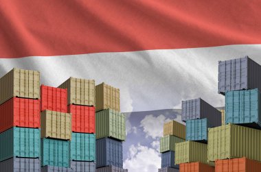 Yemen flag and big stack of shipping cargo containers in docks with sky background close up clipart