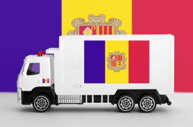 Andorra flag depicted on side wall of white delivery van close up. Shipping and local delivery concept clipart