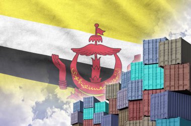 Brunei Darussalam flag and big stack of shipping cargo containers in docks with sky background close up clipart