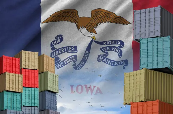 stock image Iowa US state flag and big stack of shipping cargo containers in docks with sky background close up