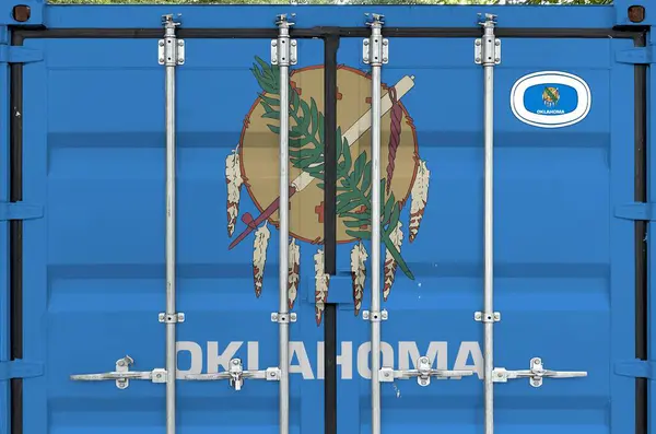 stock image Oklahoma US state flag depicted on metal doors of shipping cargo container outdoors in docks area close up