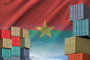 Burkina Faso bayrağı ve rıhtımdaki büyük kargo konteynırları.