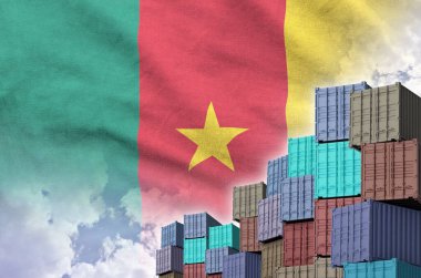 Cameroon flag and big stack of shipping cargo containers in docks with sky background close up clipart