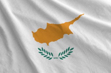 Cyprus flag depicted on folded wavy fabric of old cloth close up clipart