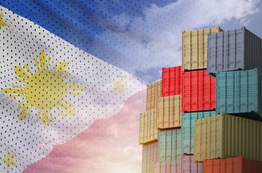 Filipinler bayrağı ve yükleme konteynırları rıhtımlarda ve gökyüzü arka planında yakın çekim