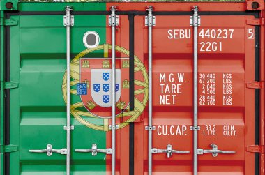 Portugal flag depicted on metal doors of shipping cargo container outdoors in docks area close up clipart