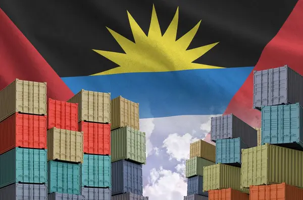 stock image Antigua and Barbuda flag and big stack of shipping cargo containers in docks with sky background close up