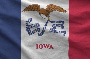 Iowa US state flag depicted on folded wavy fabric of old cloth close up clipart