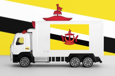 Brunei Darussalam flag depicted on side wall of white delivery van close up. Shipping and local delivery concept clipart