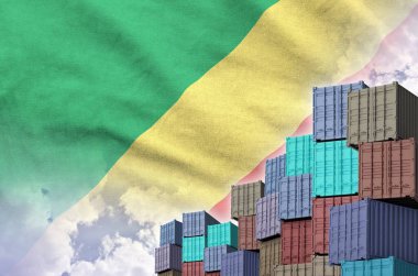 Congo flag and big stack of shipping cargo containers in docks with sky background close up clipart