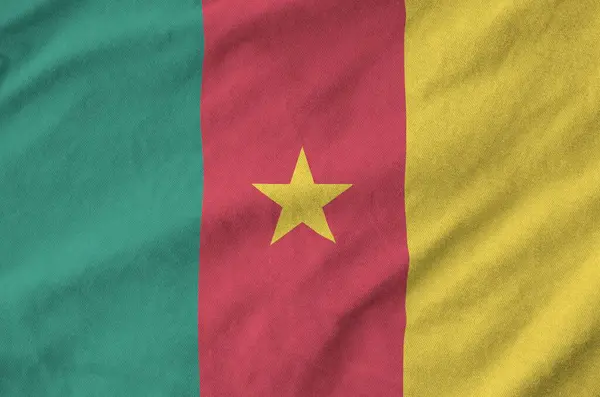 Stock image Cameroon flag depicted on folded wavy fabric of old cloth close up