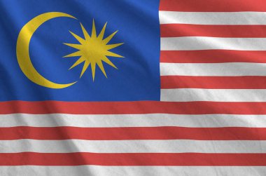 Malaysia flag depicted on folded wavy fabric of old cloth close up clipart