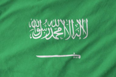 Suudi Arabistan bayrağı eski kumaşların katlanmış dalgalı kumaşında tasvir edilmiştir.