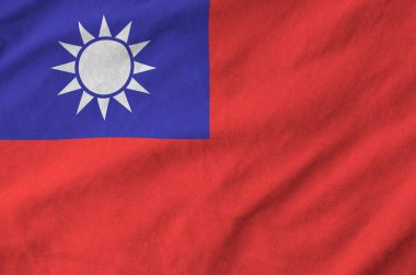 Taiwan flag depicted on folded wavy fabric of old cloth close up clipart