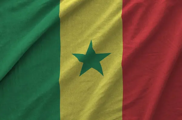 stock image Senegal flag depicted on folded wavy fabric of old cloth close up