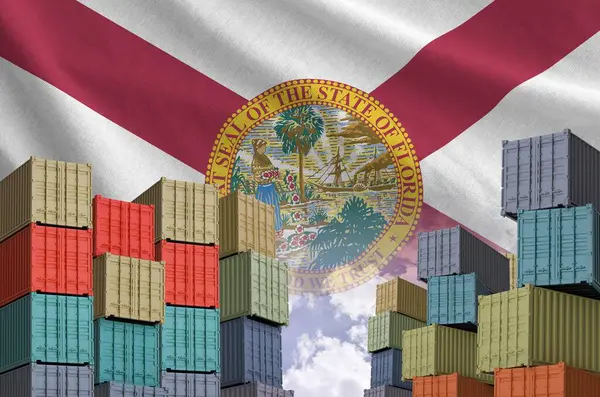 stock image Florida US state flag and big stack of shipping cargo containers in docks with sky background close up