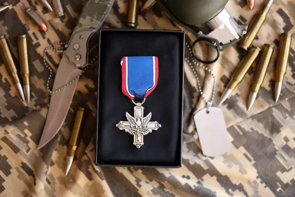 stock image KYIV, UKRAINE - JULY 10, 2024 Distinguished Service Cross medal. United States military award medal with ribbon and pin. Handmade paper theater props close up