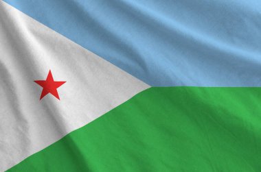 Djibouti flag depicted on folded wavy fabric of old cloth close up clipart