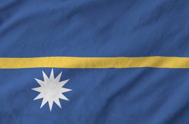 Nauru flag depicted on folded wavy fabric of old cloth close up clipart