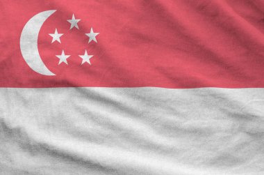 Singapore flag depicted on folded wavy fabric of old cloth close up clipart