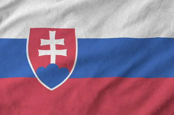 stock image Slovakia flag depicted on folded wavy fabric of old cloth close up