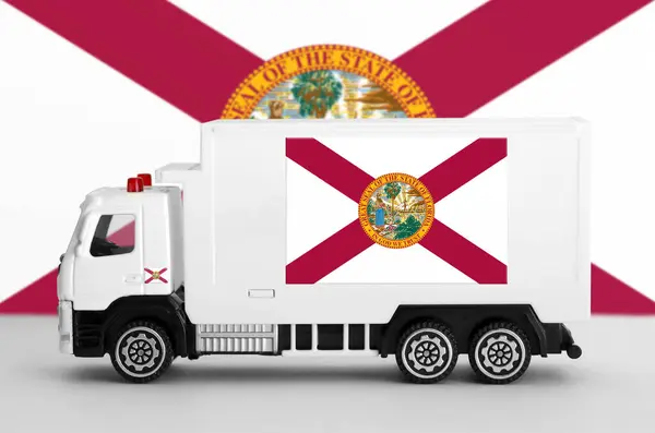 stock image Florida US state flag depicted on side wall of white delivery van close up. Shipping and local delivery concept